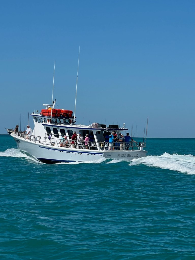 Boat in the ocean with "Miss Belle" written on the stern 